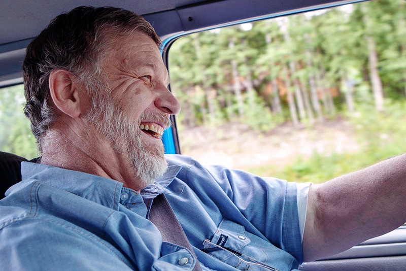 Man smiling while driving