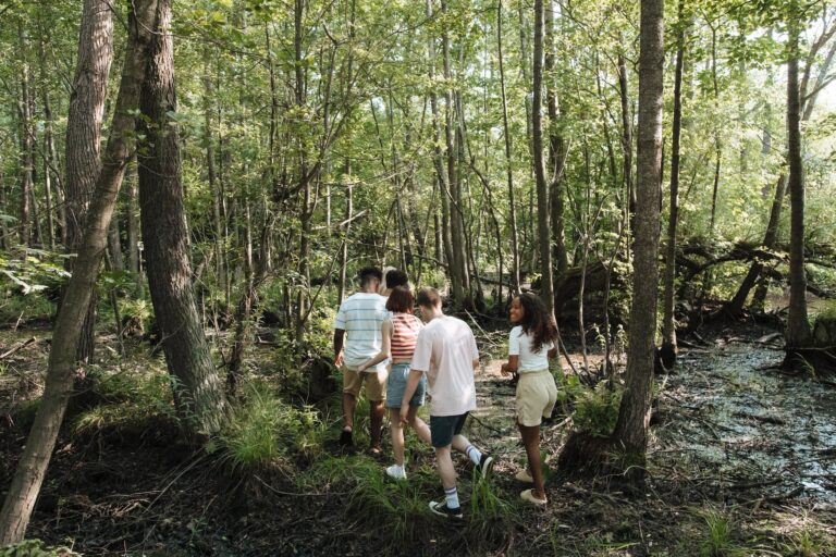Group of Teenagers Walking Through Forest